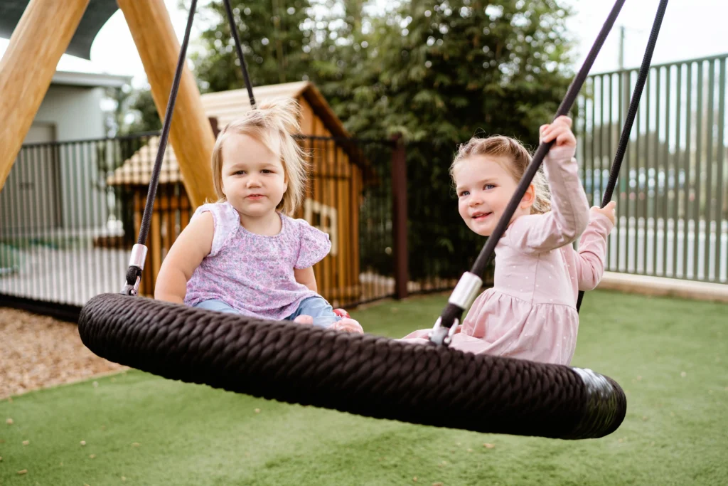 children playing on a swing at a childcare centre