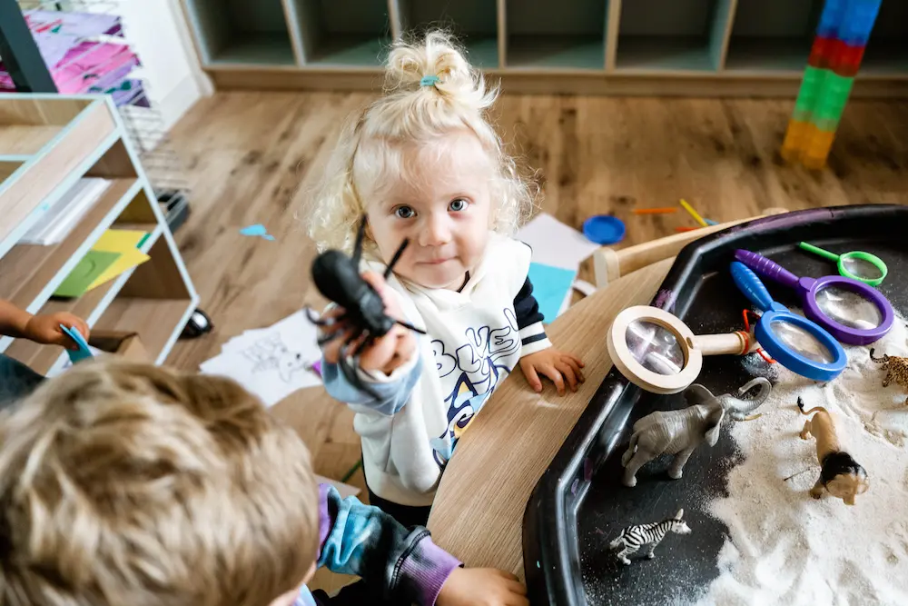 little boy playing with toys in a childcare centre